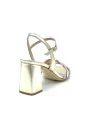 Gold laminate leather and glittery fabric sandal with intertwined band. Leather 