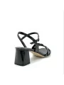 Black patent leather sandal with intertwined band. Leather lining. Leather sole.