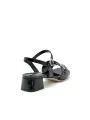 Black patent leather sandal with silver accessory. Leather lining. Leather sole.
