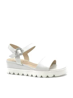 Milk leather sandal with jewel buckle. Leather lining, leather covered wedge and