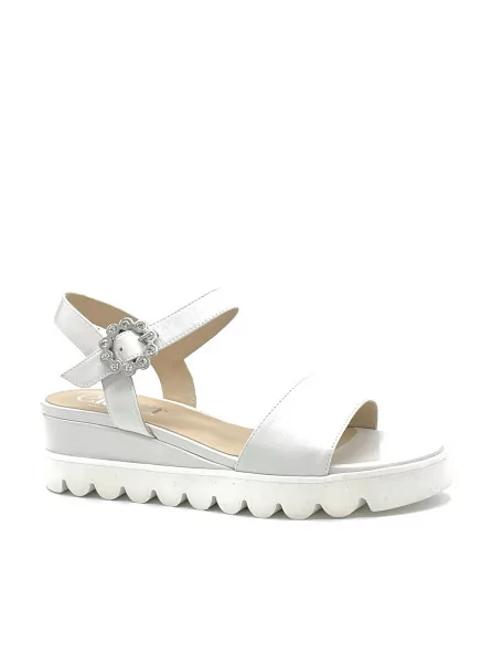 Milk leather sandal with jewel buckle. Leather lining, leather covered wedge and