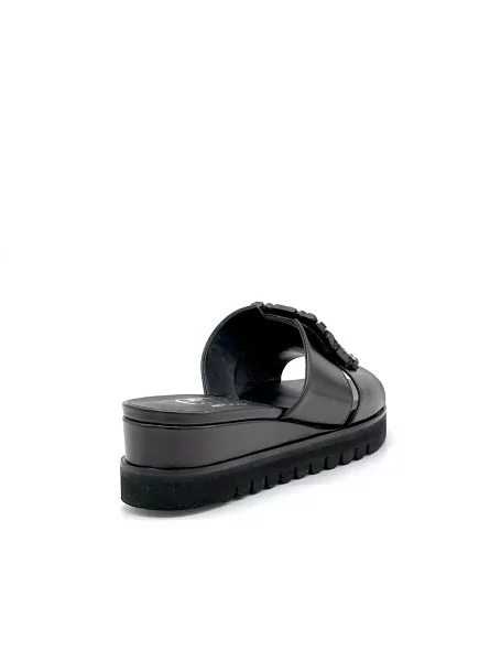 Black leather mule with jewel accessory. Leather lining, leather covered wedge a